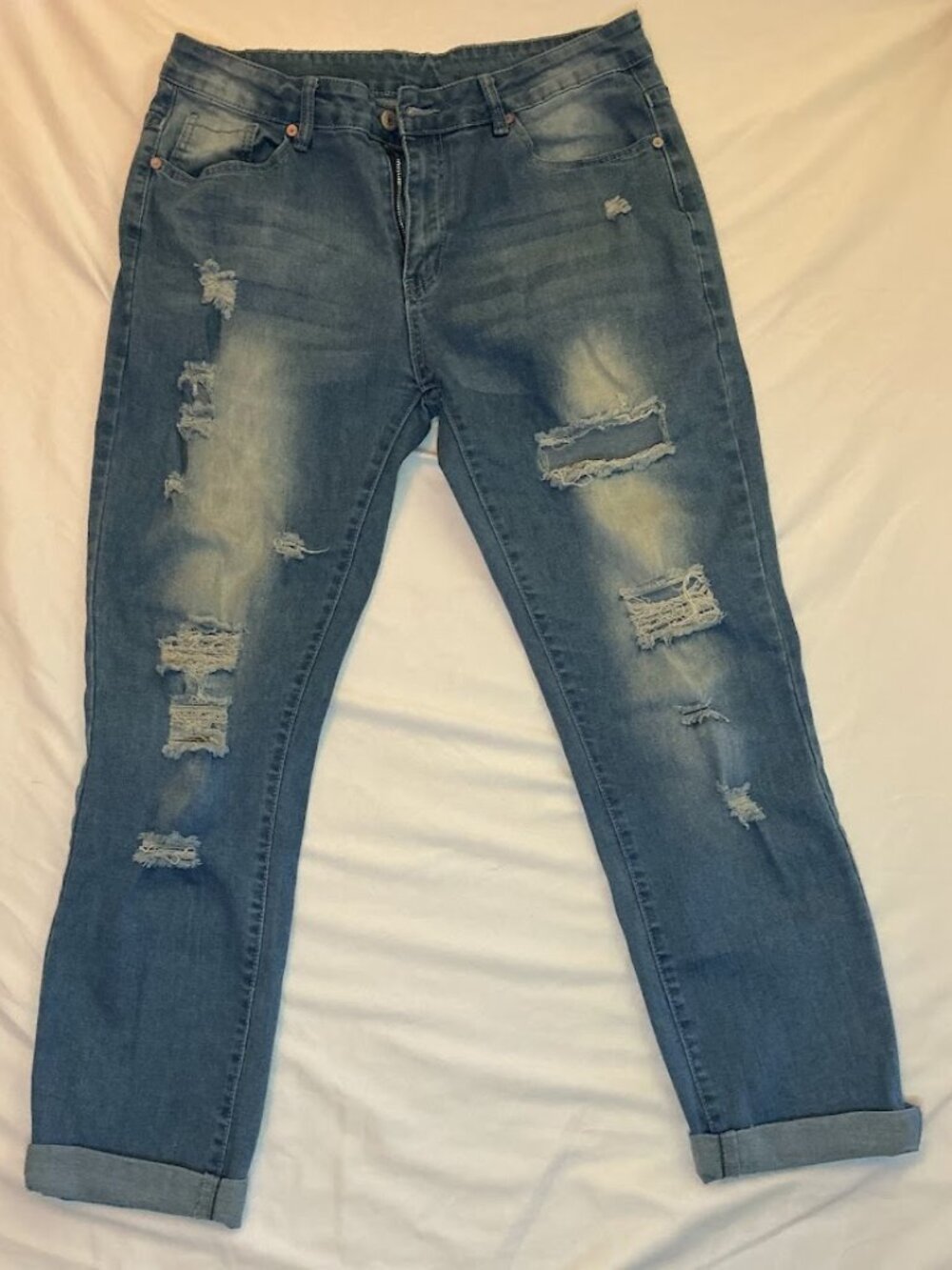 Kunmi Blue Jeans, size L, stretchy with distressed areas on front of pants.